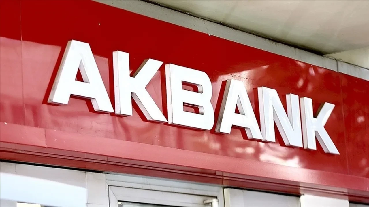 AKBANK bank sign with white 3D letters on a red storefront panel.